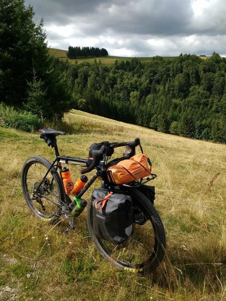 Group of cyclists pausing on a hilltop overlook